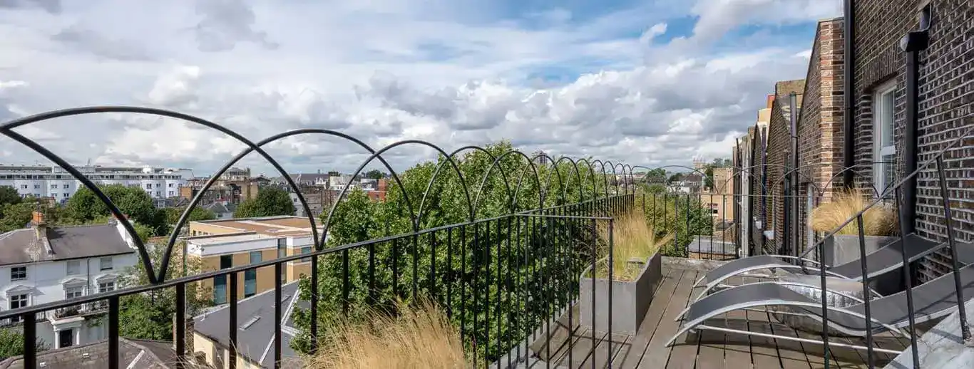 Space Apart Hotel balcony with chairs and a railing